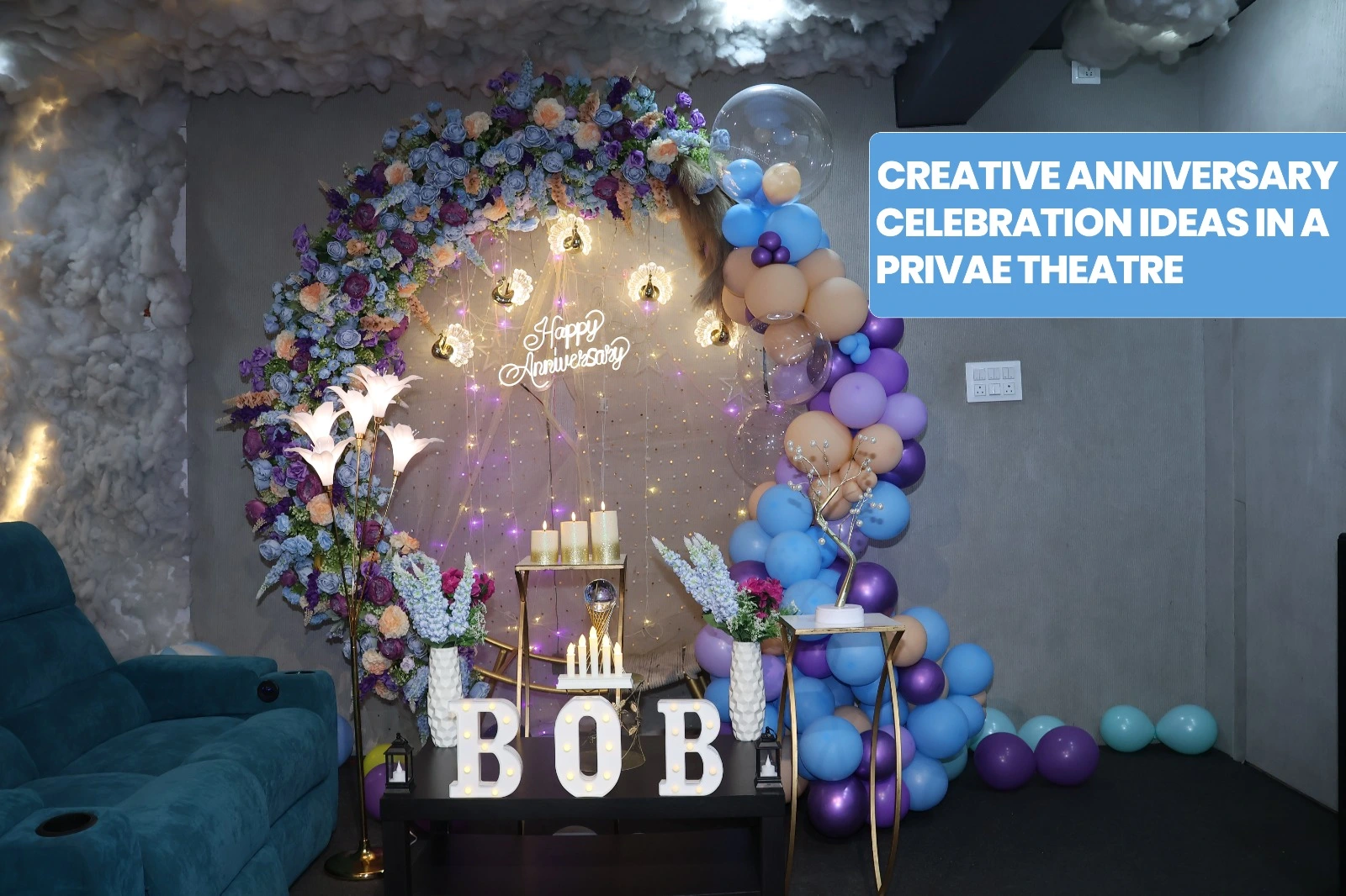 Couple celebrating anniversary in a private theatre with decorated screen, candles, and cozy seating