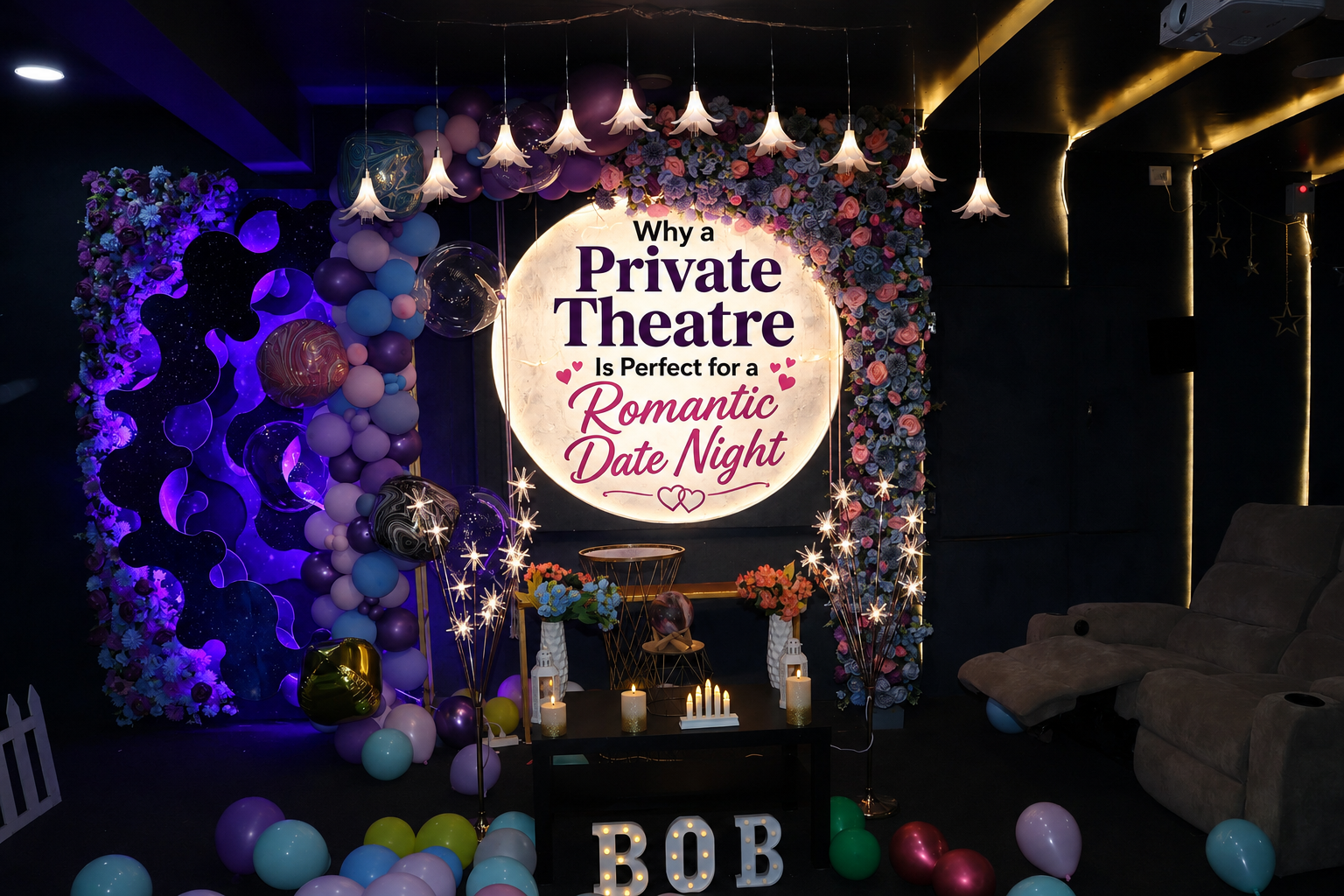 Decorated private theatre room for a date night with romantic flower wall, ambient fairy lights, marquee letters reading "BOB", balloons, and cozy reclining seating.